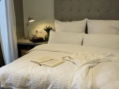 a book on top of a white bed at YVES Marrakech in Marrakech