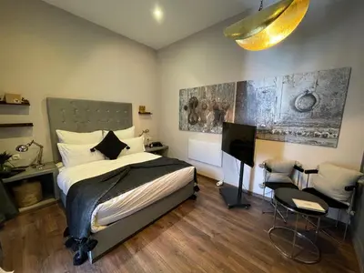 a bedroom with a bed and a desk and a television at YVES Marrakech in Marrakech