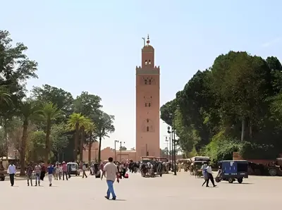 people walking around in front of a clock tower at Élégant Refuge à Deux Pas du Célèbre Jardin Majorelle in Marrakech