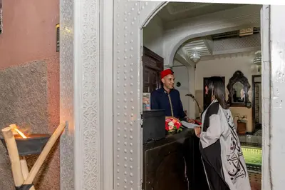 a man and a woman standing at a counter at Riad HAFSSA & Spa in Marrakech