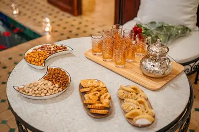 a table topped with plates of food and bowls of snacks at Riad Privé Dar L'Étoile - Jacuzzi Piscine & Petit Déj inclus in Marrakech