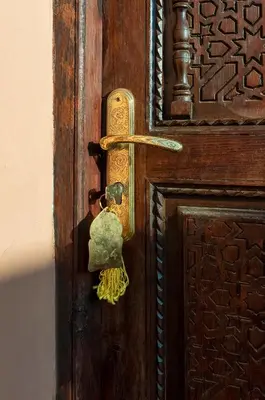 a wooden door with a brass door knocker on it at Riad Privé Dar L'Étoile - Jacuzzi Piscine & Petit Déj inclus in Marrakech