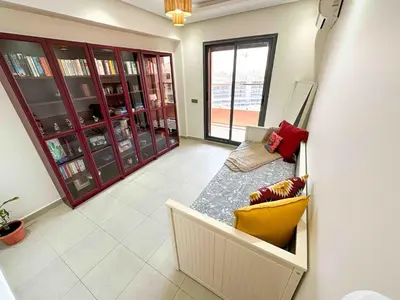 a living room with a couch and a table at Jardin Majorelle Cozy Apartment in Marrakech