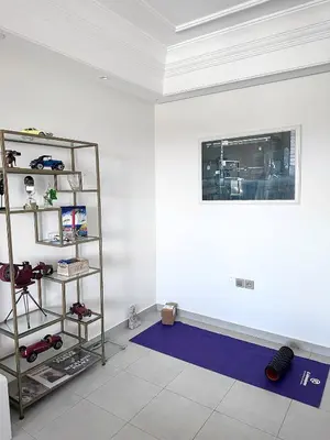 a room with a white wall and a purple rug at Jardin Majorelle Cozy Apartment in Marrakech