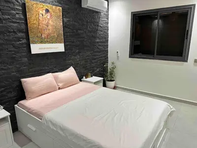 a bedroom with a bed with a brick wall at Jardin Majorelle Cozy Apartment in Marrakech