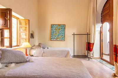 a bedroom with two beds and a lamp in it at Riad Dar Al Barakaa - EXCLUSIVE - Breakfast in Marrakech