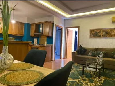 a living room with a table and a couch at Appartement cosy quartier au centre de Marrakech Gueliz in Marrakech