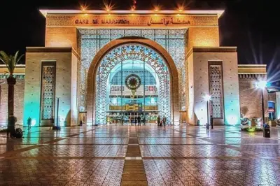 a large building with a large entrance at night at Appartement Nour 5 Marrakech in Marrakech