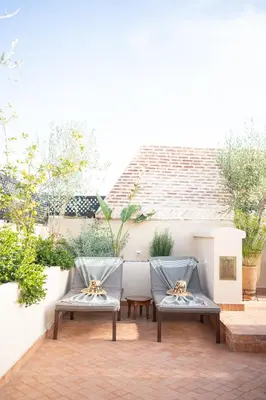two chairs sitting on top of a patio at Riad IMPERIA in Marrakech