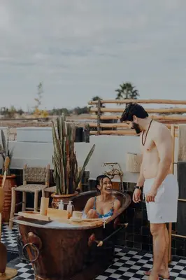 a man standing in a bath tub with a woman at Le Petit Kenzara & magical rooftop in Marrakech