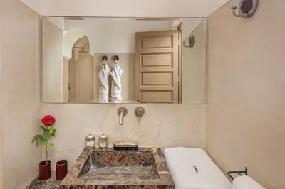 a bathroom with a sink and a mirror at Riad Jaaneman in Marrakech