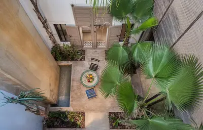 an overhead view of a courtyard with palm trees at Riad Jaaneman in Marrakech