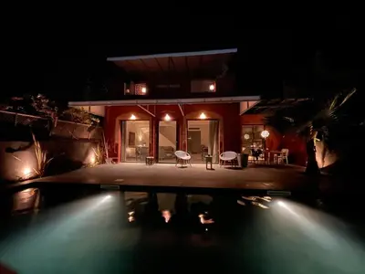 a house with a swimming pool at night at La Villa 2A, Palmeraie, Marrakech in Marrakech