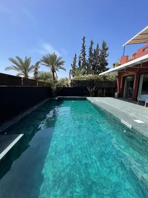 a swimming pool in the backyard of a house at La Villa 2A, Palmeraie, Marrakech in Marrakech