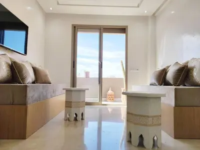 a living room with two couches and a large window at Plein centre Marrakech, grand balcon filant in Marrakech
