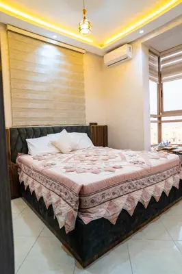 a bedroom with a large bed in a room at L'horizon Aéroport Appartement in Marrakech