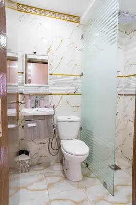 a bathroom with a toilet and a sink at L'horizon Aéroport Appartement in Marrakech