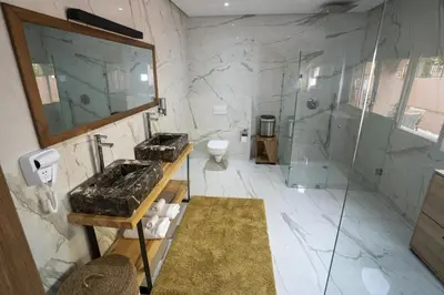 a bathroom with a shower and a sink and a toilet at Villa zéphyr in Marrakech