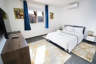 a bedroom with a bed and a flat screen tv at Villa zéphyr in Marrakech