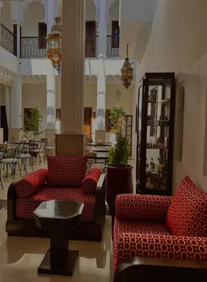 a lobby with two couches and a table and chairs at Riad Mandana & Spa in Marrakech