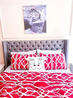 a bedroom with a bed with red and white pillows at Apartment for Rent Luxury Stay Near to Jemaa el-Fnaa in Marrakech