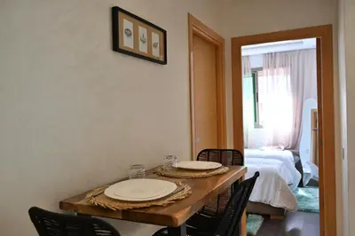 a dining room table with chairs and plates on it at Apartment for Rent Luxury Stay Near to Jemaa el-Fnaa in Marrakech