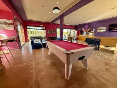 a large room with a pool table in it at Beach Mama Waky Marrakech Appartement Premium Piscine & Vue Atlas in Marrakech