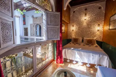 a bedroom with a bed in a room with a balcony at Riad Bed & Breakfast Comptoir du Pacha in Marrakech