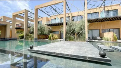 a swimming pool in front of a building at Duplex Moderne 233m2 dans une magnifique résidence in Marrakech