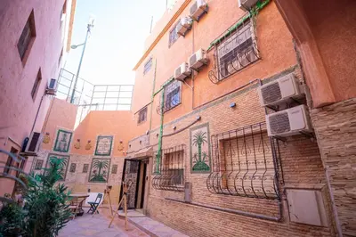 a brick building with a balcony on the side of it at Riad QAYS in Marrakech