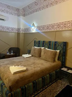 a bedroom with a bed with a beam of light at Riad La Perla Bianca in Marrakech