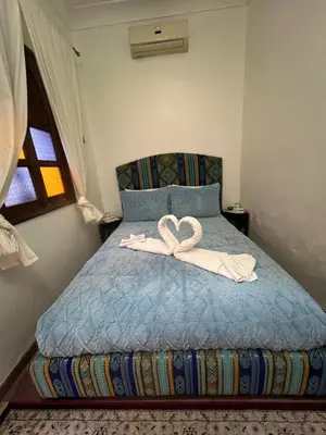 a bed with a bow on top of it at Riad La Perla Bianca in Marrakech