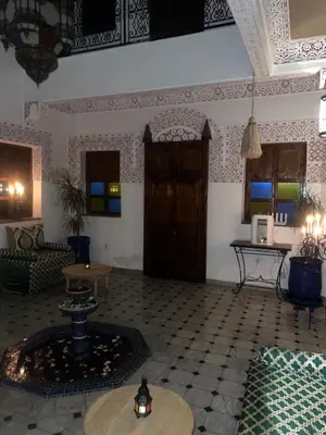 a living room with a couch and a table at Riad La Perla Bianca in Marrakech