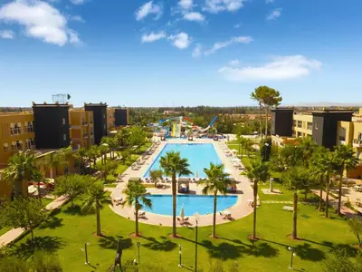 an aerial view of the pool at a resort at El Olivar Palace Marrakech All Inclusive, Aquapark & SPA in Marrakech