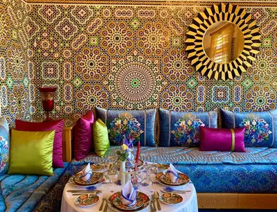a living room with a blue couch and a mirror at El Olivar Palace Marrakech All Inclusive, Aquapark & SPA in Marrakech