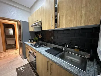 a kitchen with a sink and a stove at Appartement propre au centre de Marrakech in Marrakech
