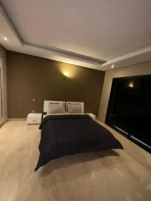 a bedroom with a large bed in a room at studio avec terasse carre eden iptv wifi in Marrakech