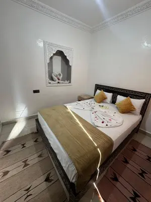 a bedroom with a bed in a room at Riad Douja in Marrakech
