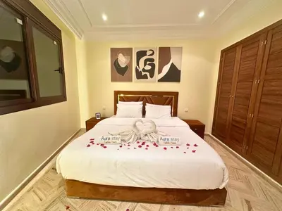 a bedroom with a bed with red roses on it at Résidence Soltana, Marrakech in Marrakech