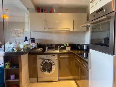 a kitchen with a washing machine and a washer at Superbe pied à terre sur Majorelle in Marrakech