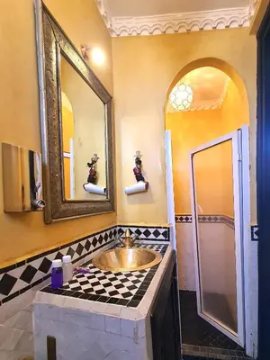 a bathroom with a sink and a mirror at Riad Jaime in Marrakech