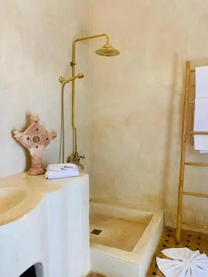 a bathroom with a shower with a sink and a lamp at Riad Casa nomad in Marrakech