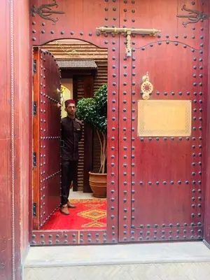 a man standing in the doorway of a building at Palais Aix Kabaj &Spa in Marrakech