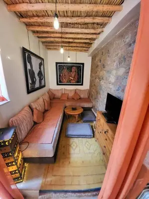 a living room with a couch and a tv at Atypique appart proche J. El fna in Marrakech