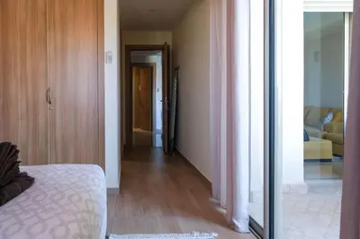 a bedroom with a bed and a room with a hallway at Magnifique appart vue piscine in Marrakech