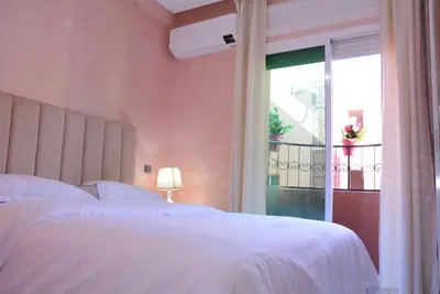 a bedroom with a white bed and a window at apartment Marrakech, gueliz in Marrakech