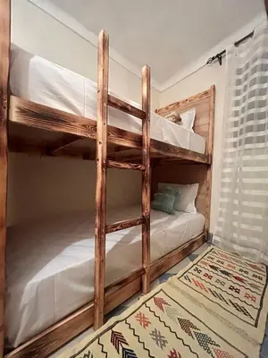 two bunk beds in a room with a rug at Peekaboo Hostel in Marrakech