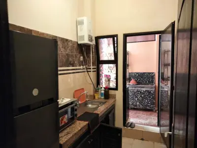 a bathroom with a sink and a window and a television at les porte de guiliz appartement in Marrakech