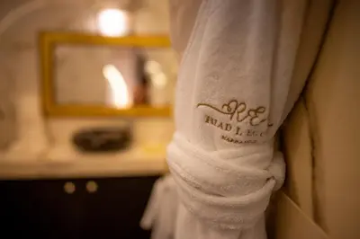 a towel with the name of a hotel written on it at Riad L'ECOLE in Marrakech