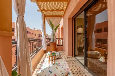 an apartment balcony with a view of the city at Le Palmier - Appartement Authentique à Gueliz in Marrakech